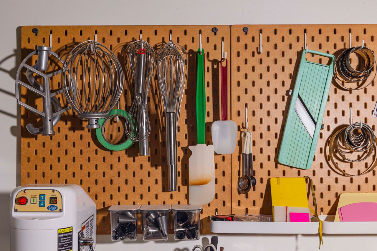 Kitchen utensils and tools hang on a pegboard at Alice Marie, a bakery in Toronto