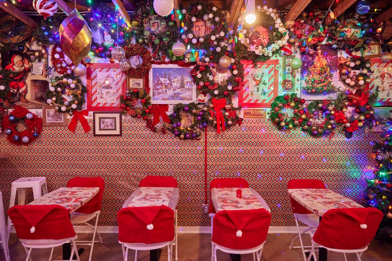 Chair backs covered with Santa hats at Miracle, a holiday-themed bar