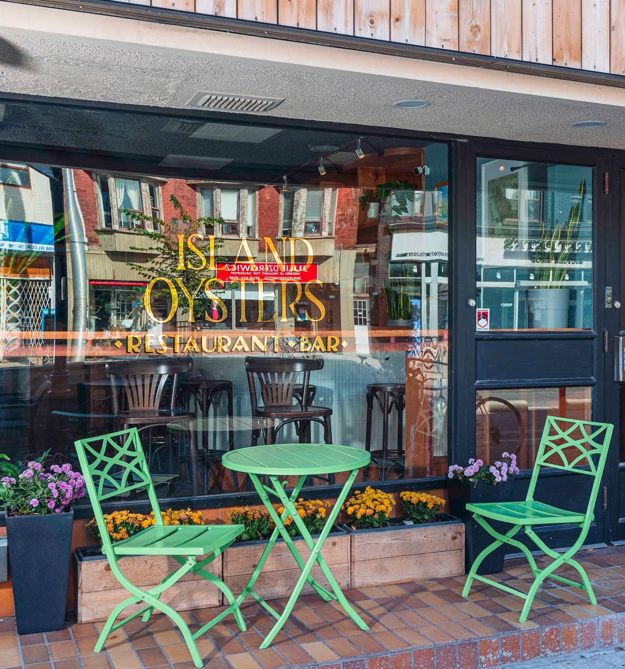 The exterior and small patio of Island Oysters in Toronto
