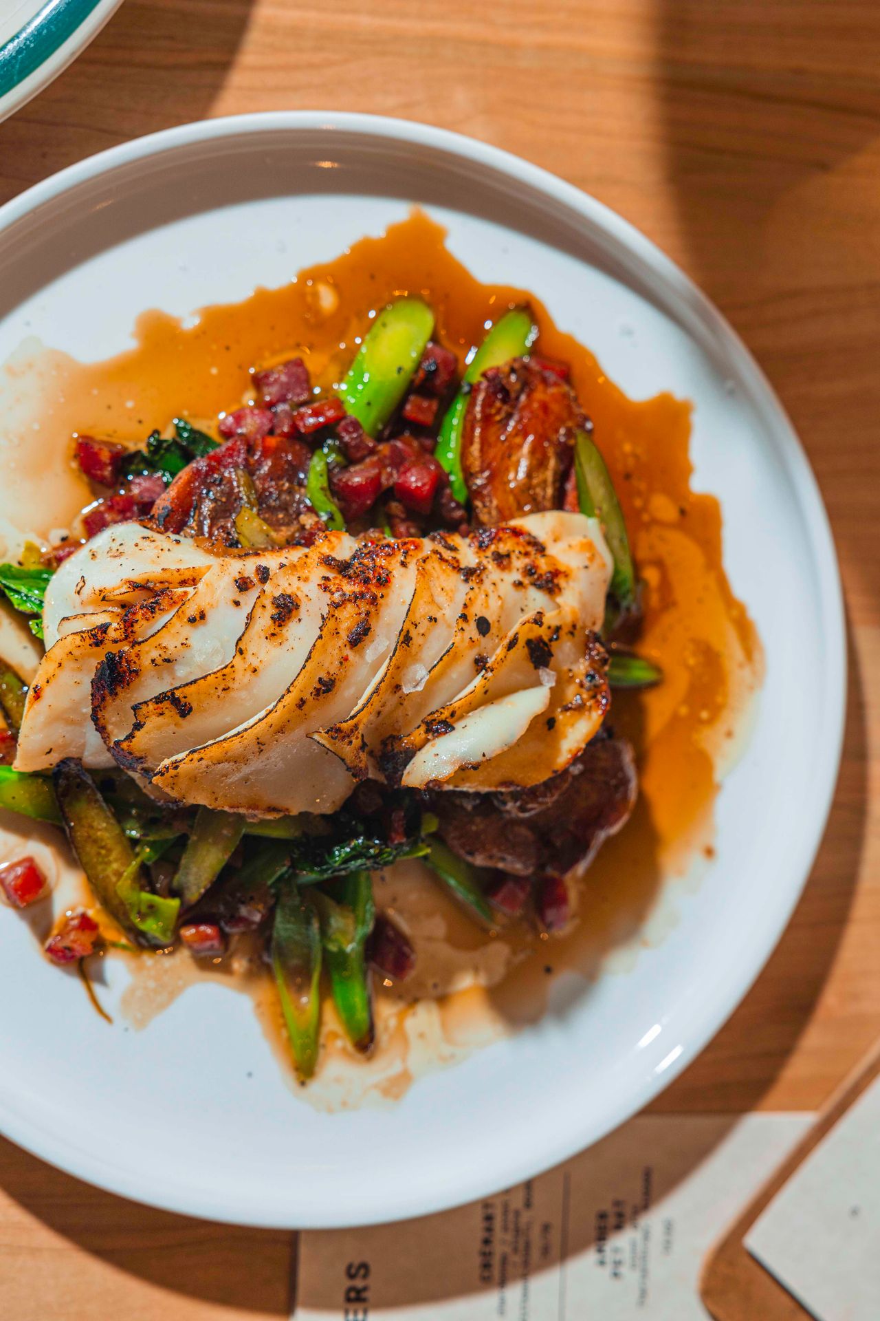Seared Humboldt Squid with lap cheong vinaigrette, steamed gai lan and new potatoes